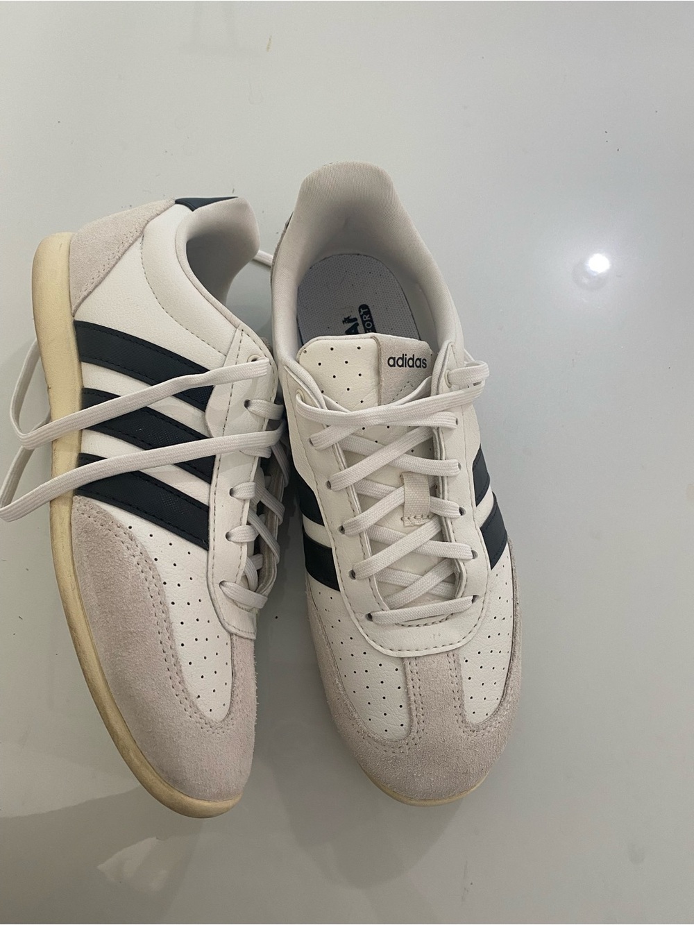 adidas Women’s White Sneakers with Black Stripes.